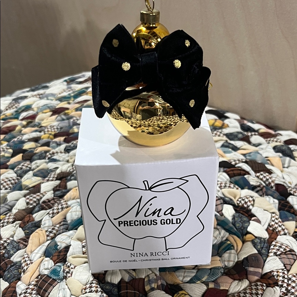 Nina Ricci Gold Ornament with Black Accent